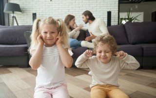 Little children boy and girl put fingers in ears not to hear parents arguing at background, son and daughter tired of family conflicts, parental arguments impact on children, divorce and kids concept