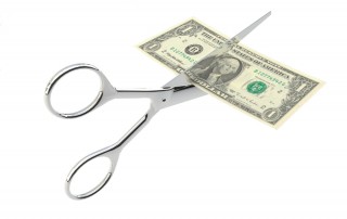 scissors cutting a dollar