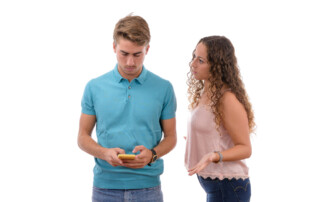 Angry couple because they are hooked to the mobile phone all day isolated in white